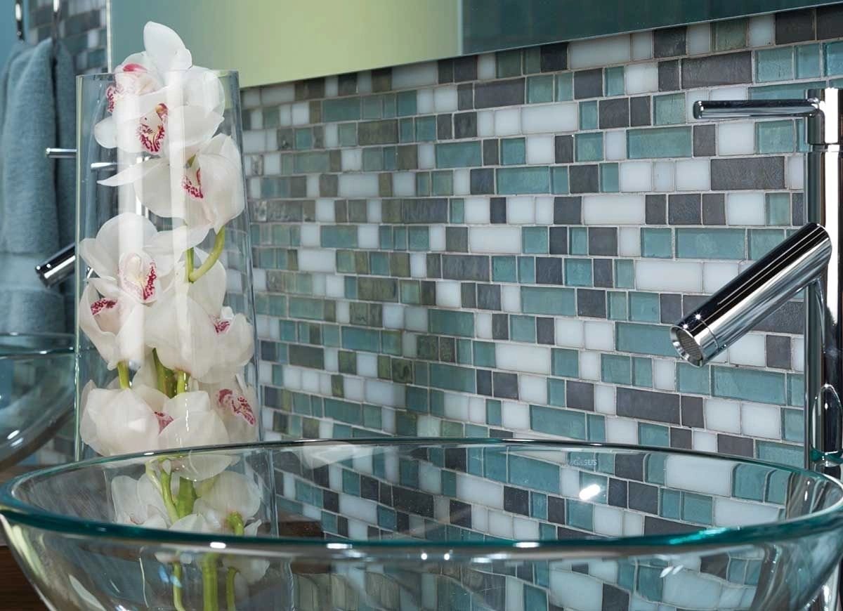 Glass mosaic tile behind a bathroom basin